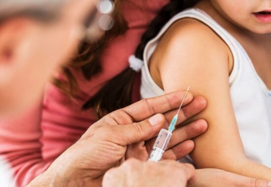 Doctor giving small child an injection